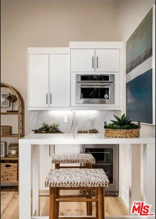a kitchen with stainless steel appliances a stove a sink and a microwave