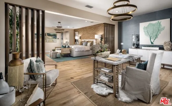 a living room with furniture and a chandelier