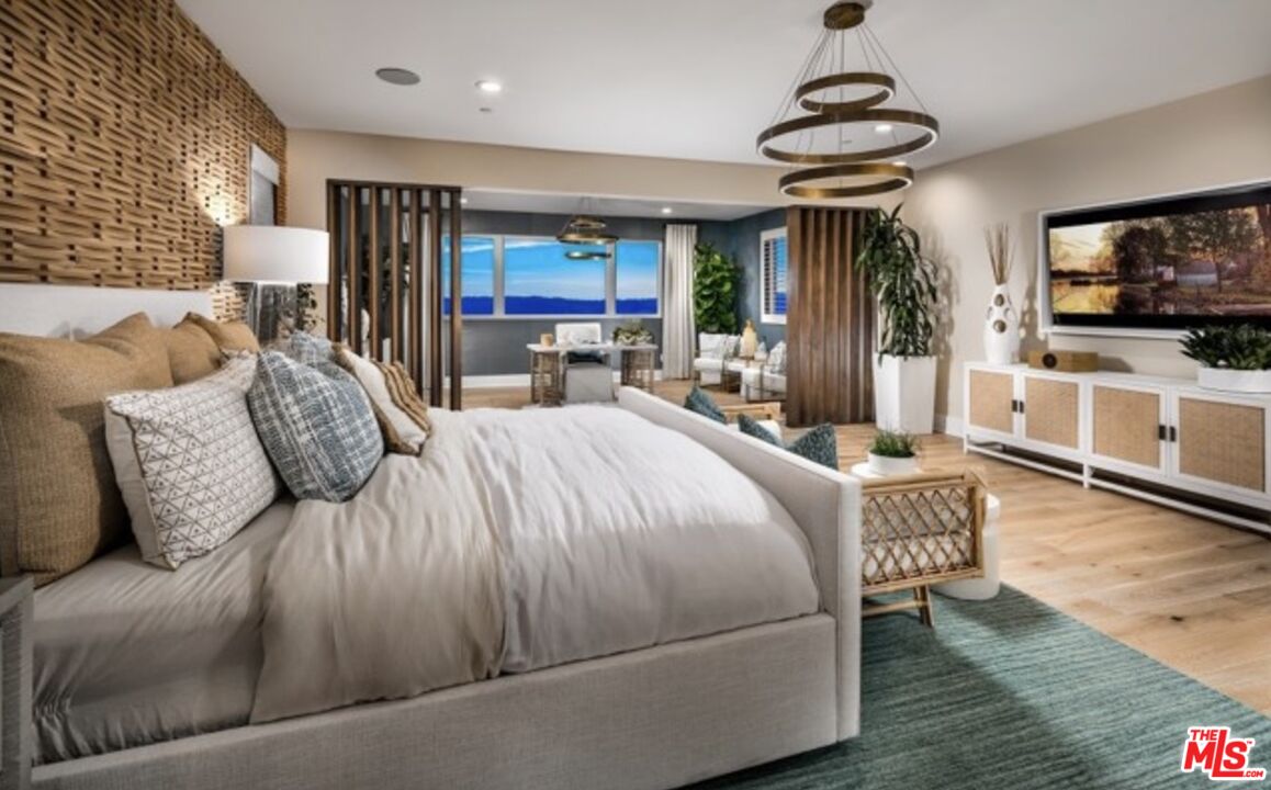 20400 Marlow Lane Porter Ranch, CA 91326 - Photo 14 of 21 a bedroom with a bed a flat screen tv and a couch