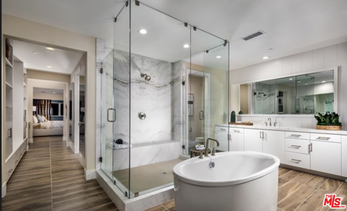 20400 Marlow Lane Porter Ranch, CA 91326 - Photo 17 of 21 a bathroom with a bathtub shower sink vanity and toilet