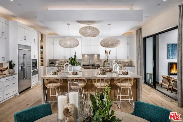 a large kitchen with a table and chairs