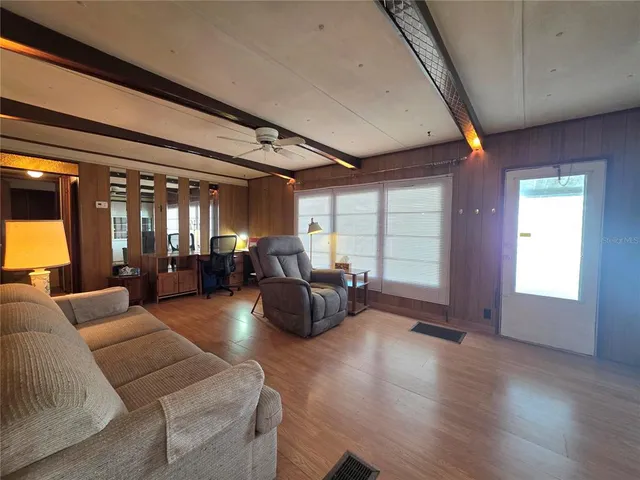 a view of a house with a big yard and a large trees