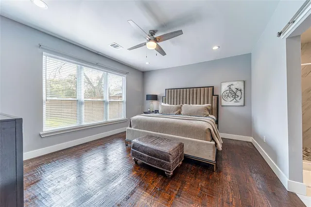 a bedroom with a large bed and a window