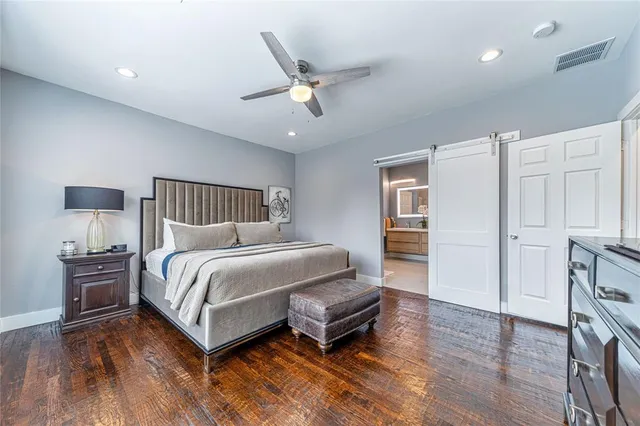 a bedroom with a bed and wooden floor