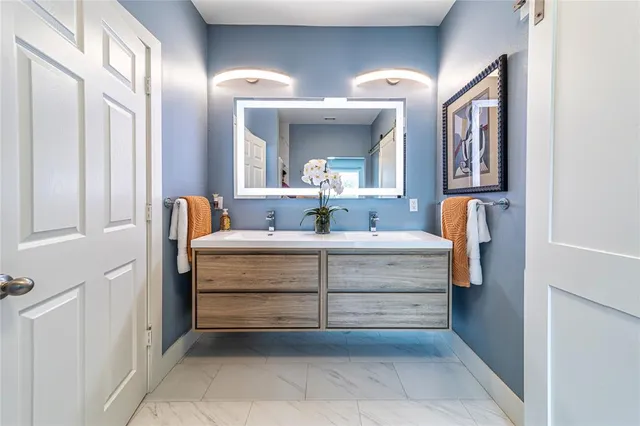 a bathroom with a sink and a mirror