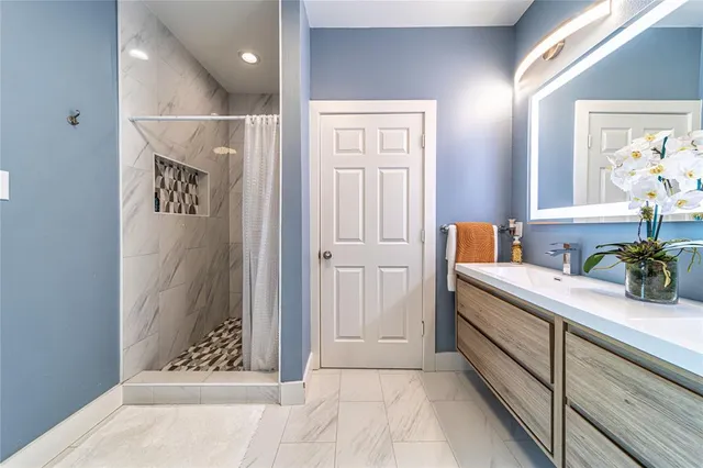 a view of hallway with window and wooden floor