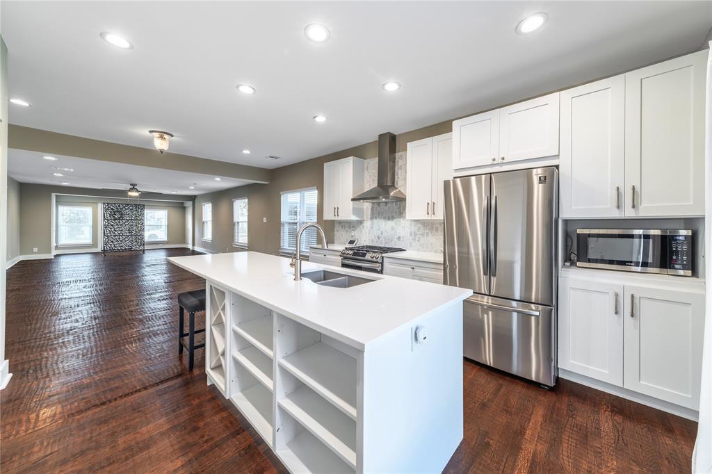 7214 Kenwell Street Dallas, TX 75209 - Photo 30 of 40 a kitchen with stainless steel appliances a refrigerator a stove a sink cabinets and wooden floor