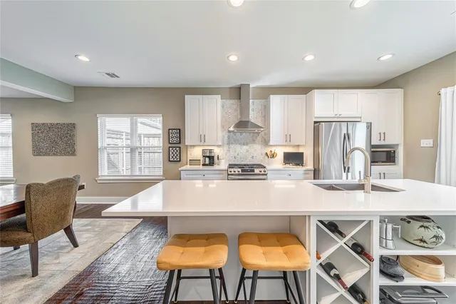 a large kitchen with kitchen island granite countertop lots of counter top space and stainless steel appliances