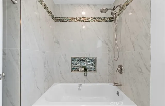 a bathroom with a bathtub and shower