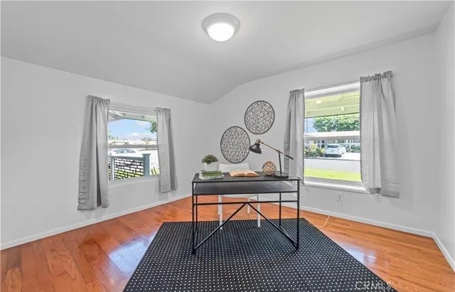 a workspace with wooden floor and a window