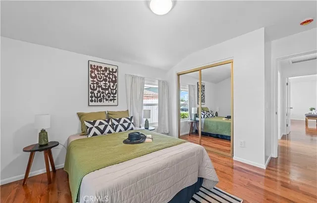 a bedroom with a bed and wooden floor