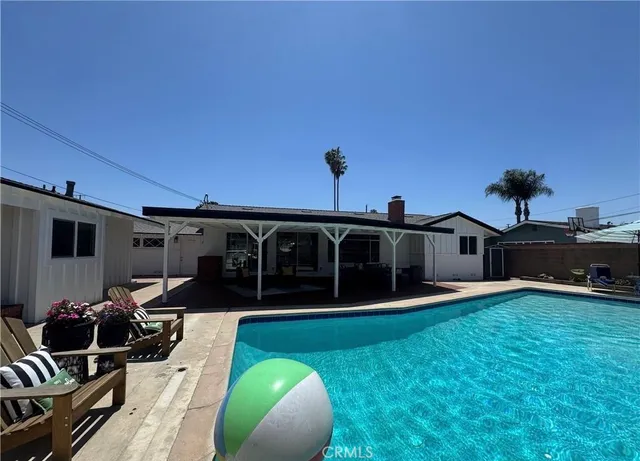 a view of a house with yard and sitting area