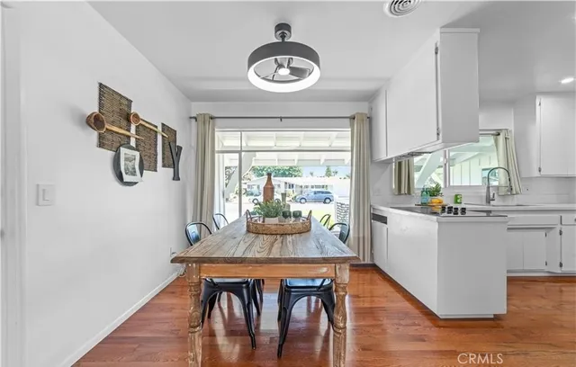 a dining room with furniture a window and wooden floor