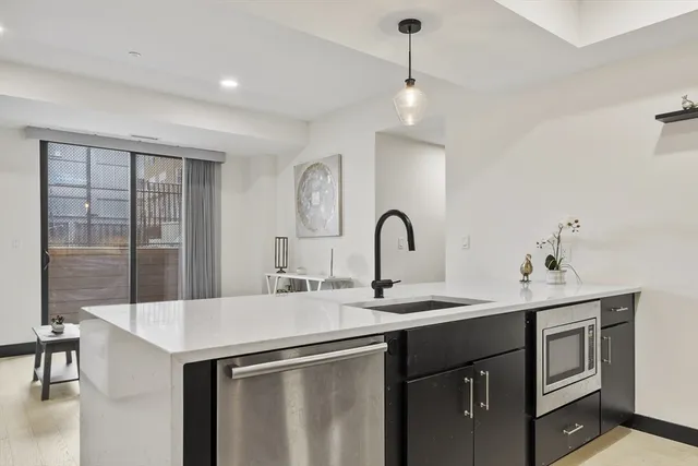 a kitchen with a sink and a stove top oven