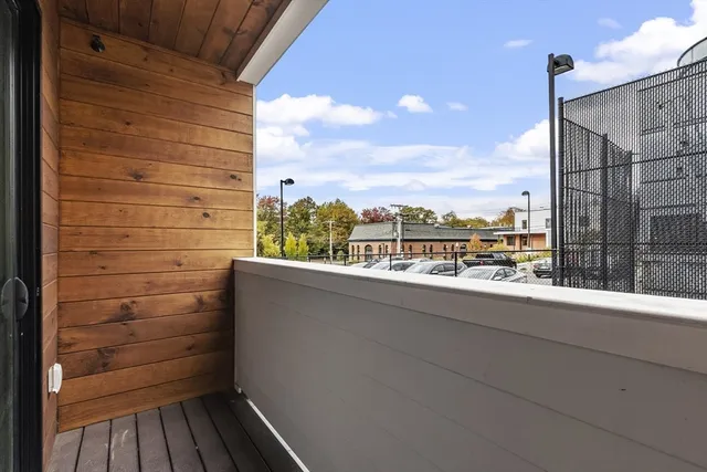 a view of a balcony with wooden floor and fence