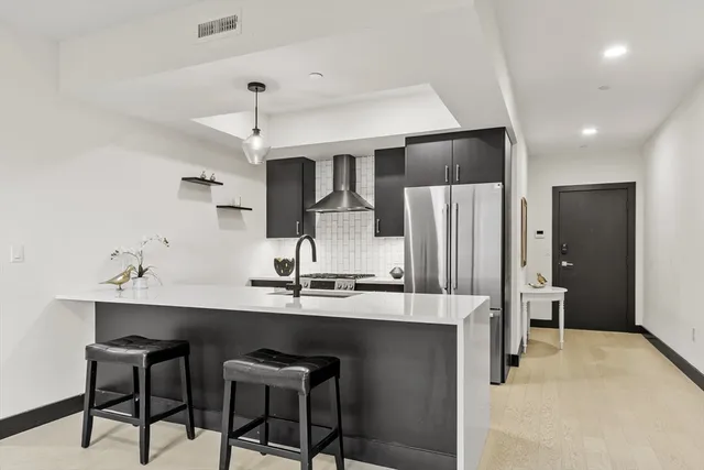 a stove top oven sitting inside of a kitchen