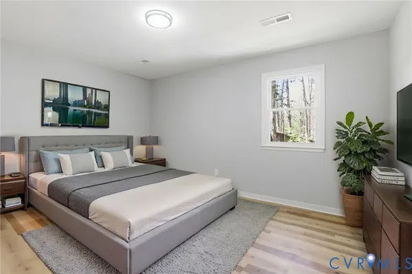 a bedroom with a bed and a potted plant