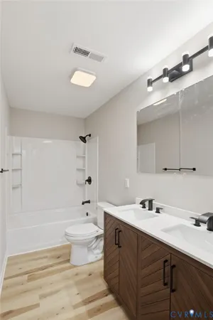 a bathroom with a sink toilet and a mirror