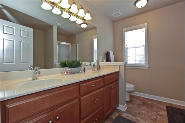 1167 Cynthia Lane Spring Hill, TN 37174 - Photo 11 of 20 a bathroom with a double vanity sink and a mirror