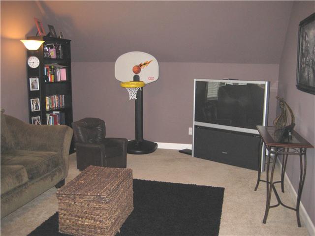 1167 Cynthia Lane Spring Hill, TN 37174 - Photo 15 of 20 a living room with furniture a potted plant and a chandelier