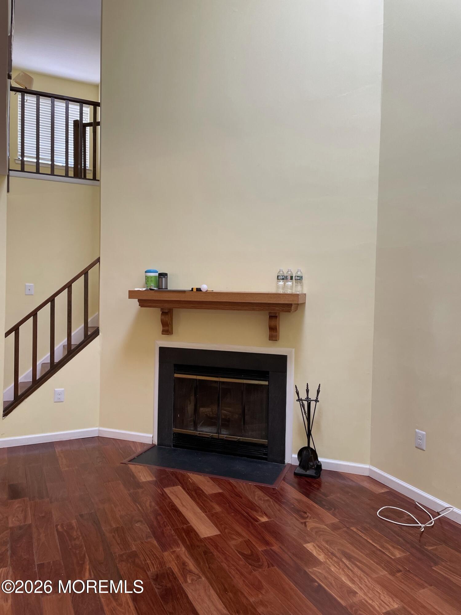 19 Clavendon Court Middletown, NJ 07748 - Photo 3 of 21 a view of an empty room with wooden floor and a fireplace