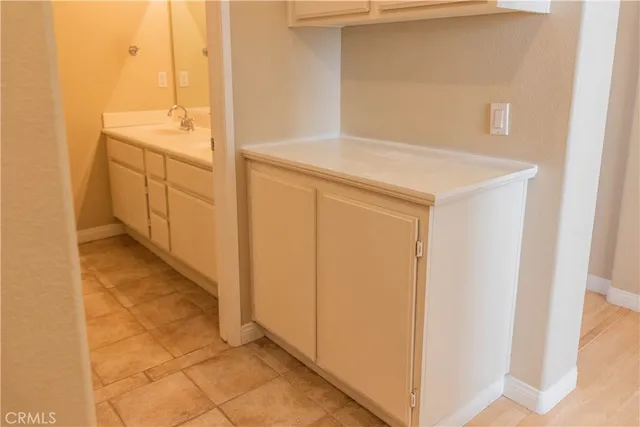 a bathroom with a granite countertop sink a mirror and a bathtub