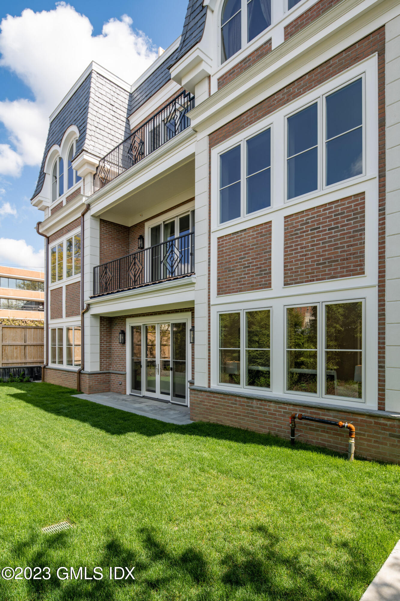 62 Mason Street, Unit 2W Greenwich, CT 06830 - Photo 17 of 18 front view of a brick building with a yard