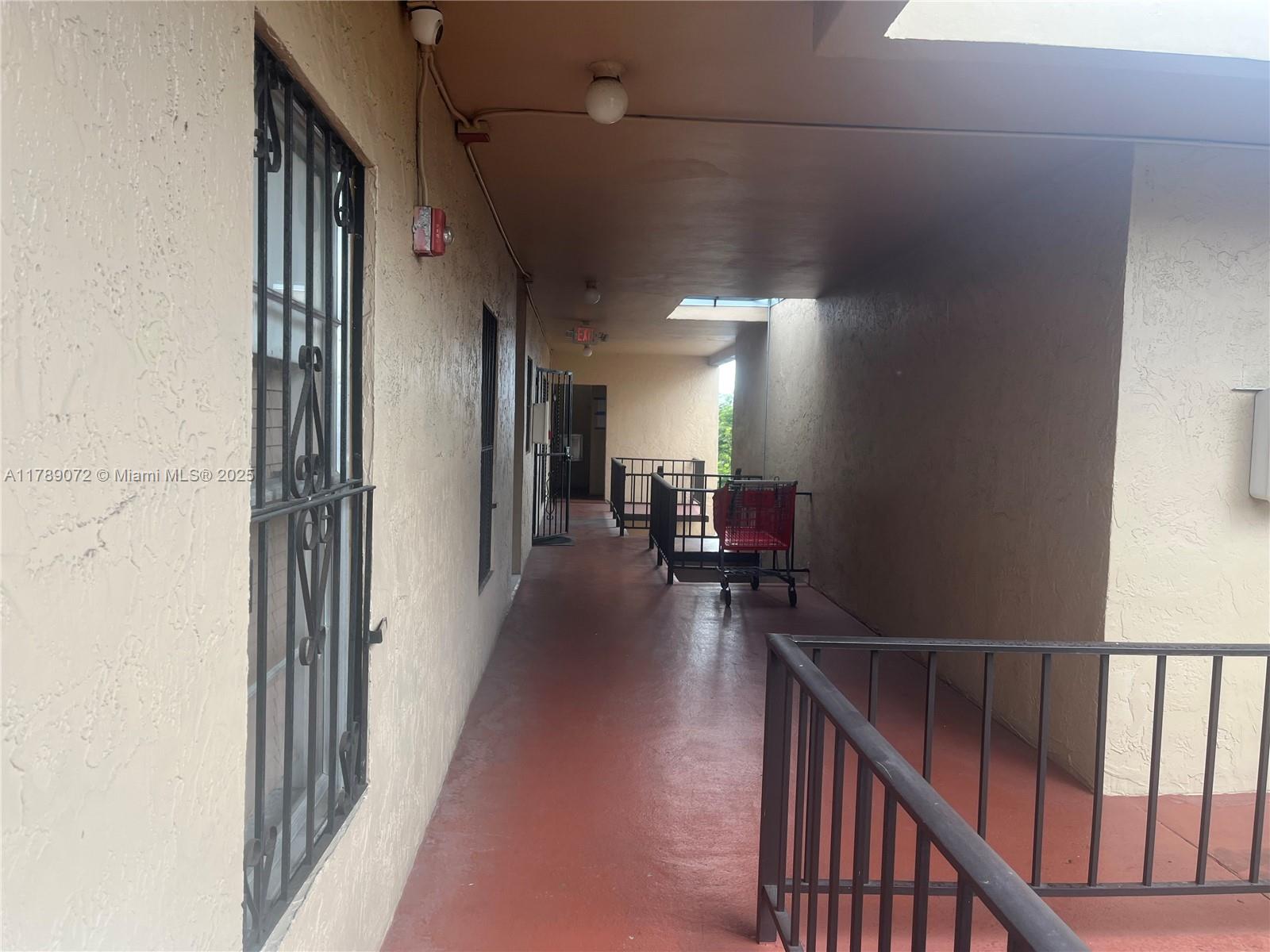10851 Southwest 2nd Street, Unit K304 Sweetwater, FL 33174 - Photo 13 of 16 a view of a hallway with wooden floor and stairs