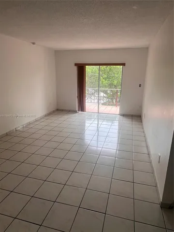 a view of an empty room and a window