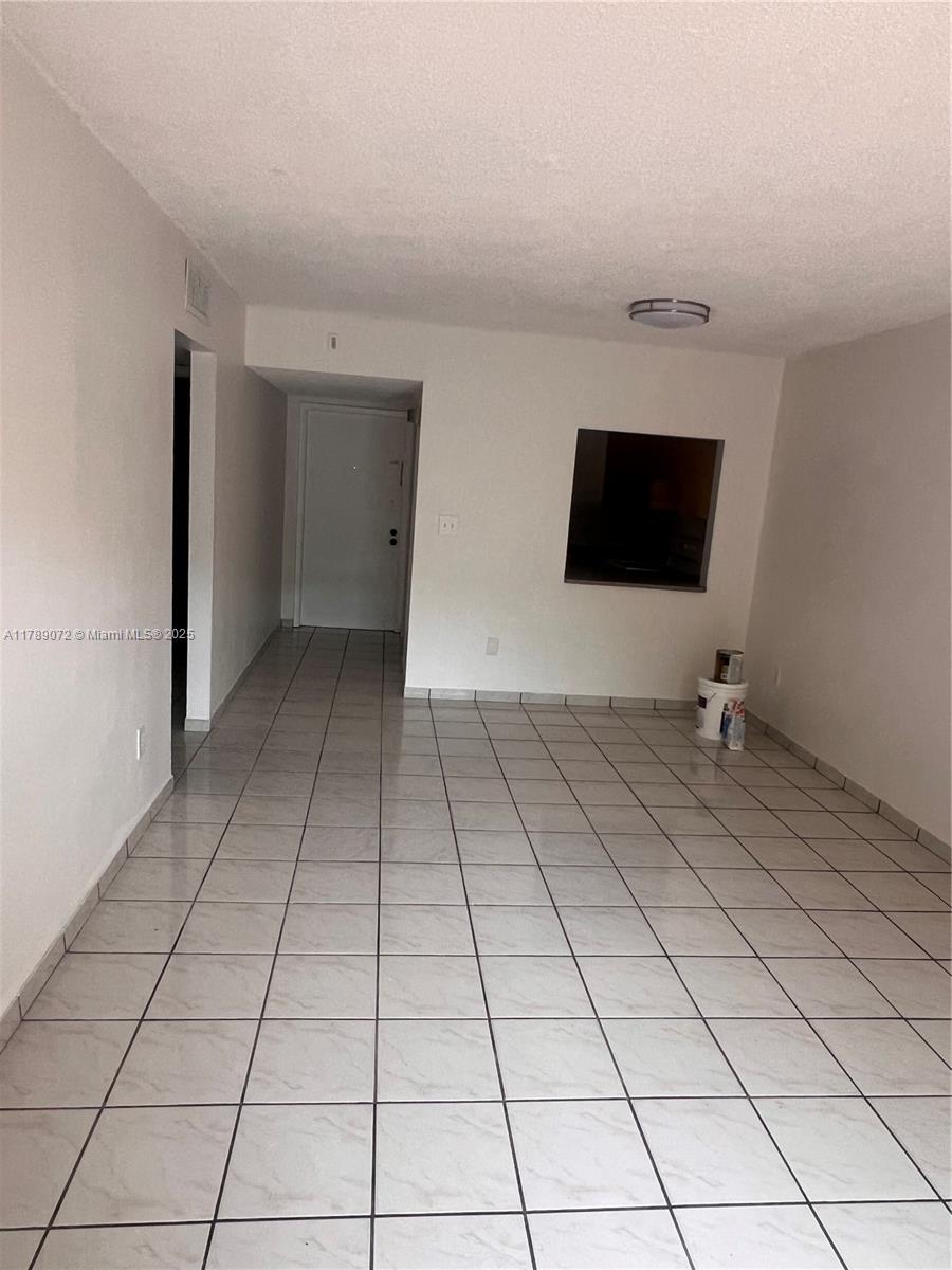 10851 Southwest 2nd Street, Unit K304 Sweetwater, FL 33174 - Photo 3 of 16 a view of a livingroom with an empty space and a flat screen tv