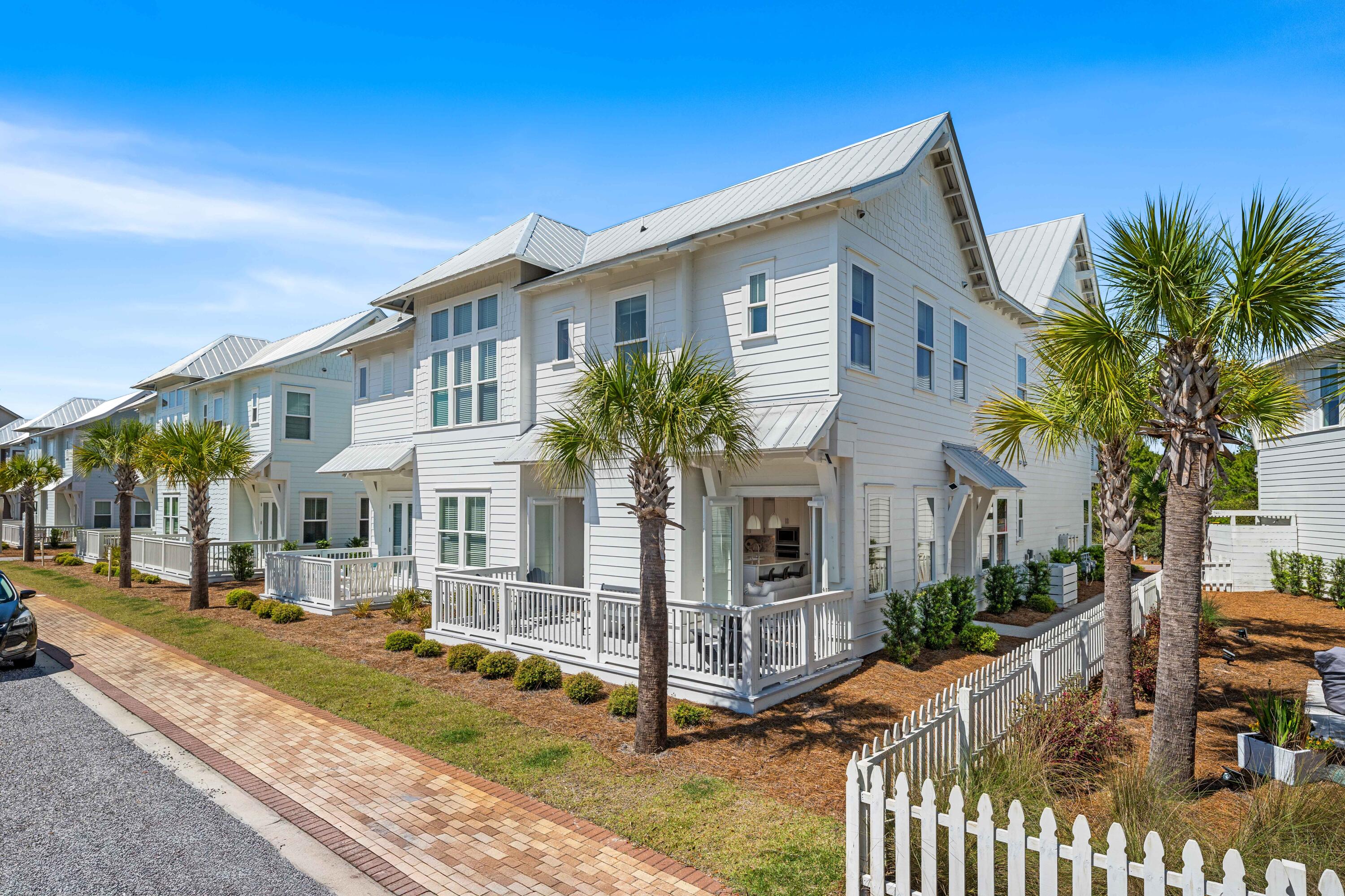 144 Wharf Ln Inlet Beach, Unit A Inlet Beach, FL 32461 - Photo 11 of 48 a view of a white house with iron fence