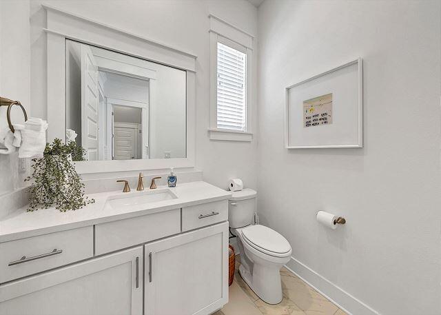 144 Wharf Ln Inlet Beach, Unit A Inlet Beach, FL 32461 - Photo 20 of 48 a bathroom with a toilet sink and mirror