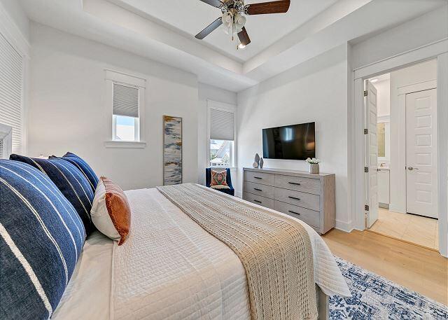 144 Wharf Ln Inlet Beach, Unit A Inlet Beach, FL 32461 - Photo 23 of 48 a bedroom with a bed and a flat screen tv