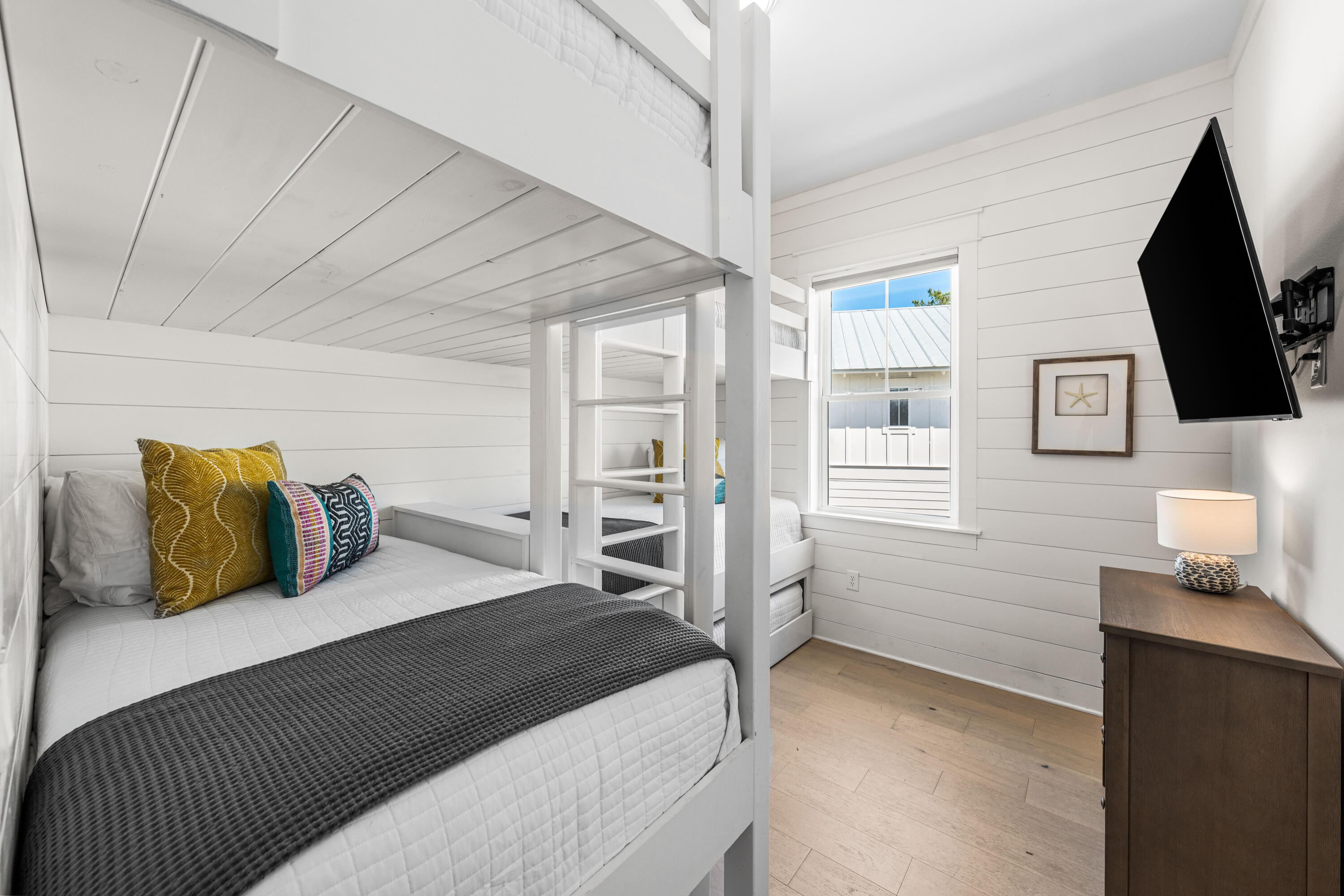 144 Wharf Ln Inlet Beach, Unit A Inlet Beach, FL 32461 - Photo 28 of 48 a bedroom with a bed and a flat screen tv
