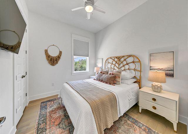 144 Wharf Ln Inlet Beach, Unit A Inlet Beach, FL 32461 - Photo 29 of 48 a bedroom with a bed and a chandelier
