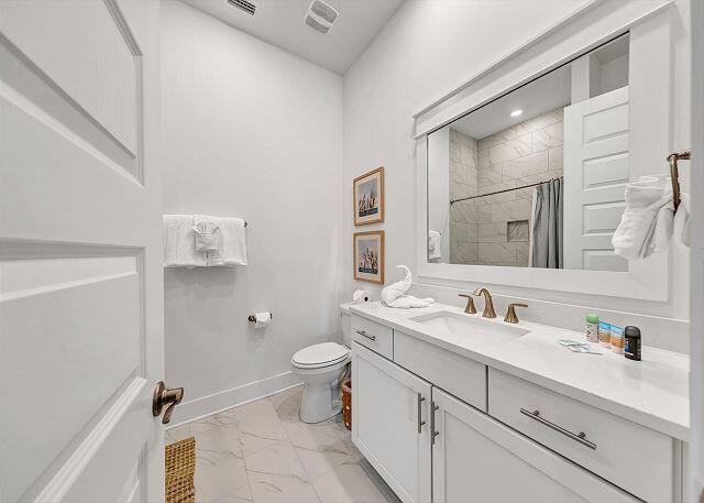 144 Wharf Ln Inlet Beach, Unit A Inlet Beach, FL 32461 - Photo 30 of 48 a bathroom with a double vanity sink mirror and toilet