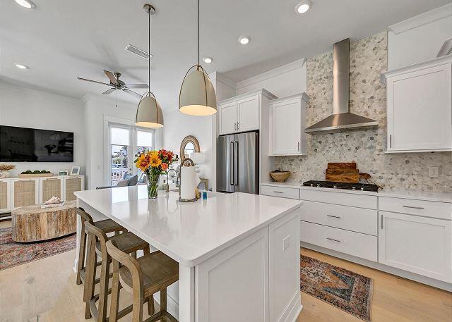 144 Wharf Ln Inlet Beach, Unit A Inlet Beach, FL 32461 - Photo 3 of 48 a kitchen with stainless steel appliances granite countertop a sink a stove and a wooden floors
