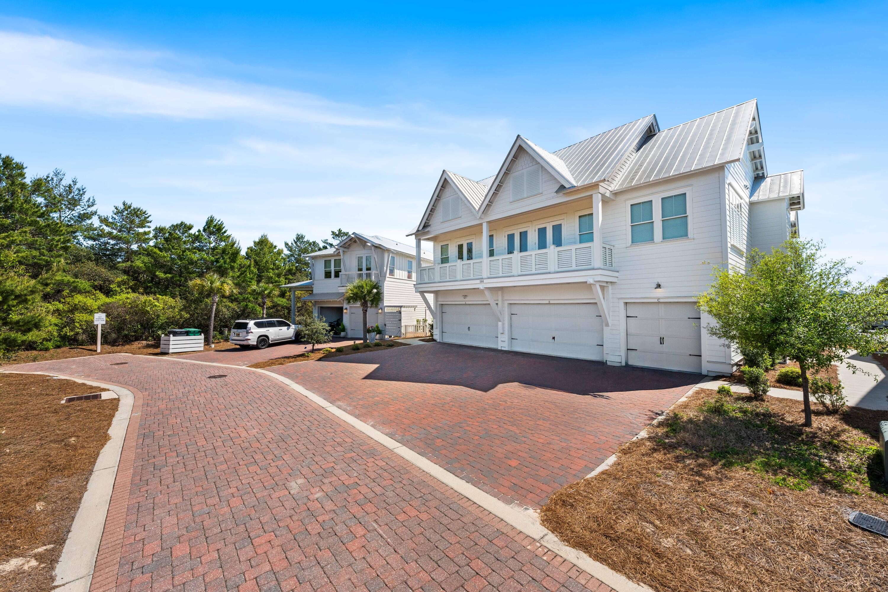 144 Wharf Ln Inlet Beach, Unit A Inlet Beach, FL 32461 - Photo 41 of 48 a front view of a house with a yard and garage