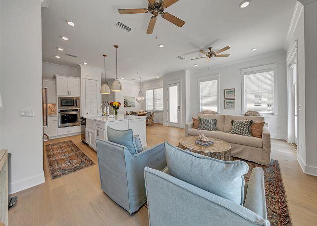 144 Wharf Ln Inlet Beach, Unit A Inlet Beach, FL 32461 - Photo 8 of 48 a living room with furniture kitchen view and a chandelier