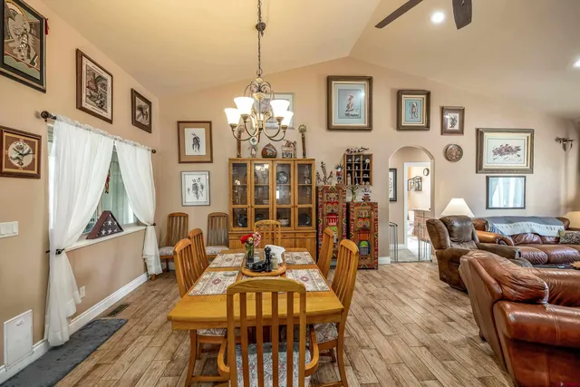 a kitchen with stainless steel appliances granite countertop a sink a stove and a refrigerator