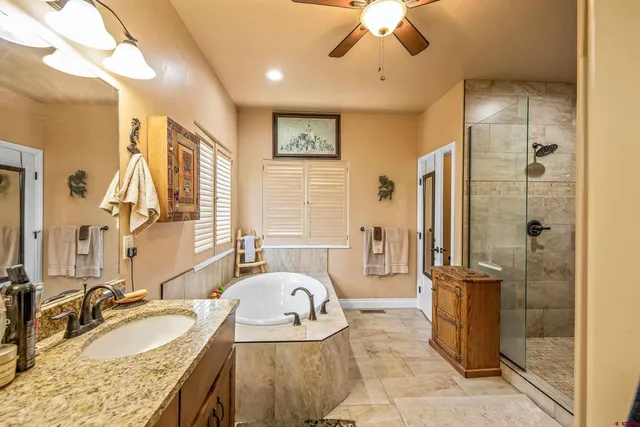 a white bath tub sitting in a bathroom next to a window