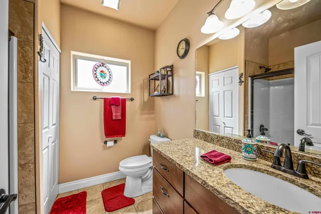 a bedroom with a bed and large windows