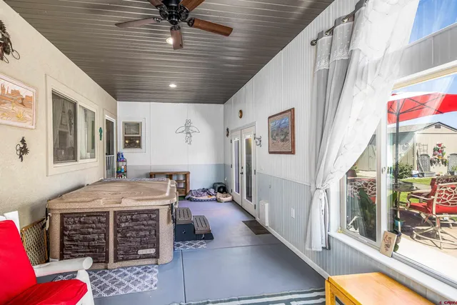 a view of a chairs and fire pit in the patio with a backyard