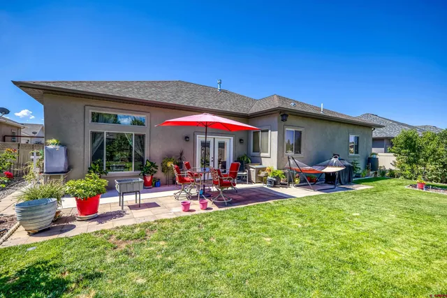 a view of a house with backyard porch and sitting area