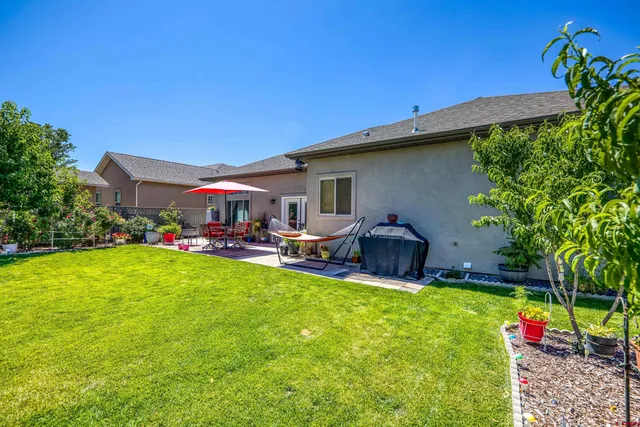 a view of a house with a big yard and potted plants