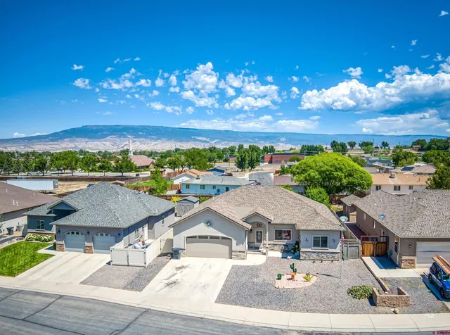 a view of a house with yard and sitting area