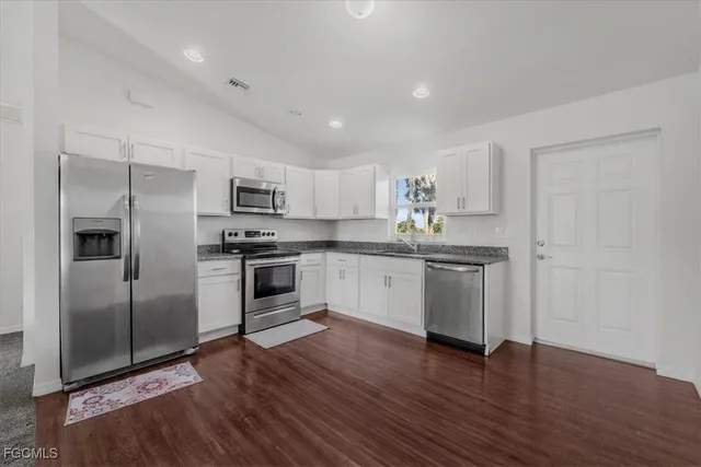 a kitchen with a refrigerator and a sink
