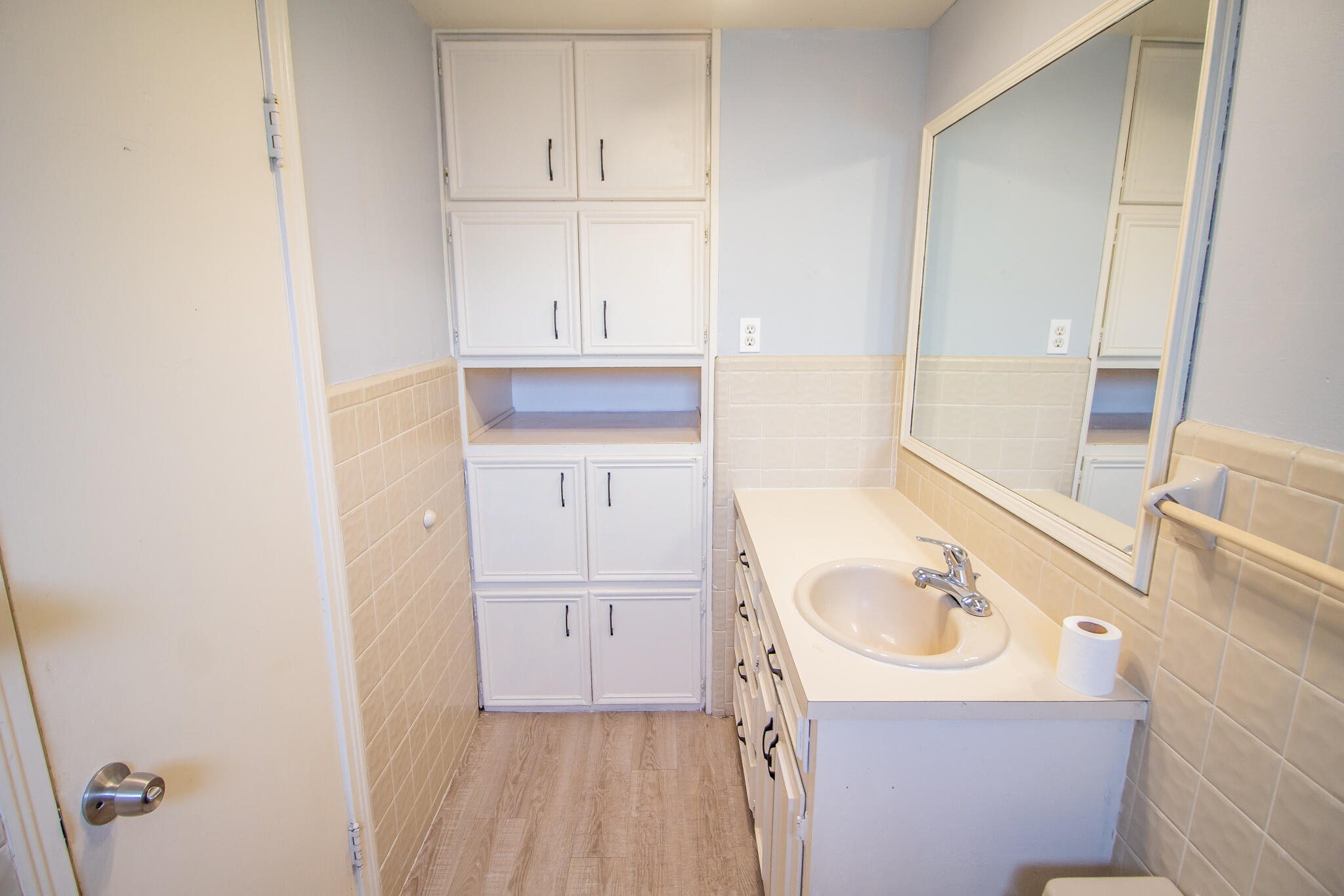 3214 27th Street Lubbock, TX 79410 - Photo 11 of 19 a bathroom with a sink and a mirror