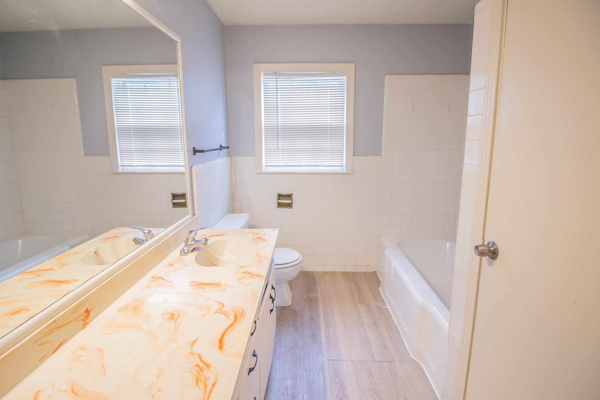 3214 27th Street Lubbock, TX 79410 - Photo 14 of 19 a bathroom with a sink and a bathtub