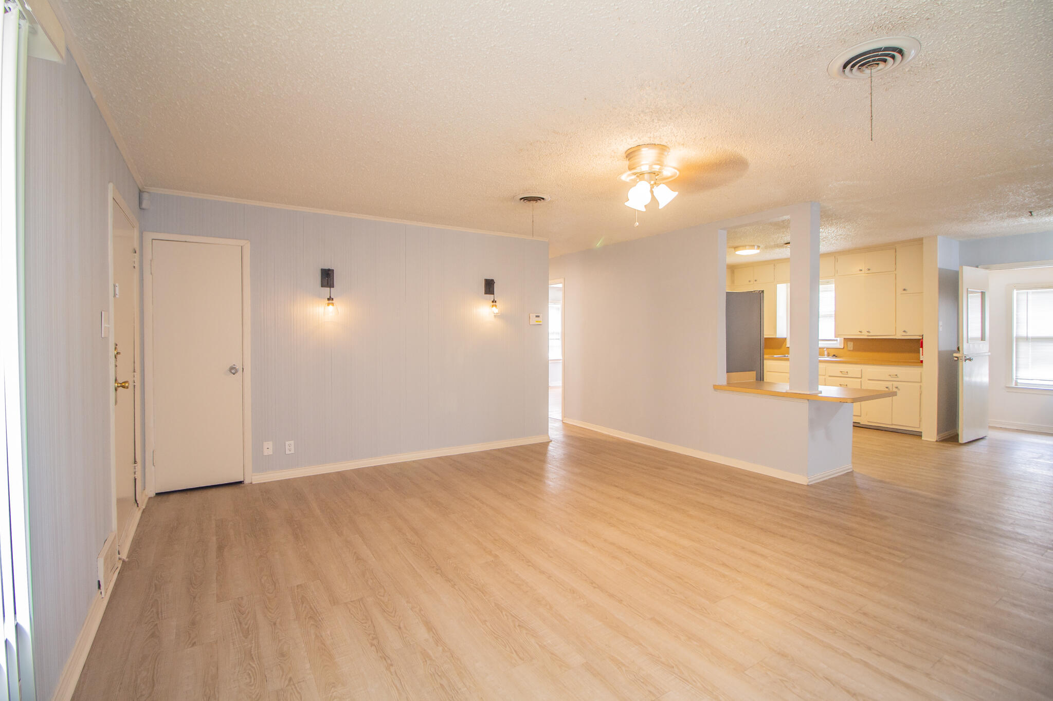 3214 27th Street Lubbock, TX 79410 - Photo 4 of 19 wooden floor in an empty room with a window